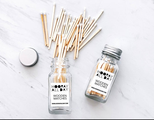 White matches in glass jar with striker on the back